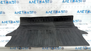 The trunk mat on the back of the seats of a Toyota Rav4 19-25 is black rubber and has a tear.