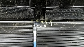 The trunk mat on the back of the seats of a Toyota Rav4 19-25 is black rubber and has a tear.