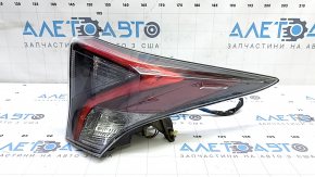 The upper right wing light of a Toyota Prius 50 16-18 has dirty glass from the inside.
