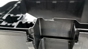 The Lexus RX350 16-22 underhood fuse box housing has a broken mount.