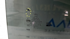 Rear left door glass of Ford Explorer 20-23, tinted, scratches
