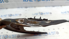 The front left brake disc cover for a Polestar 2 21-25 is dented and bent.