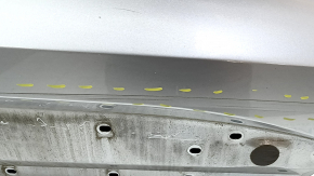 Bare front right door of a 2023 Ford Explorer, silver JS, dents, bumps, scratches