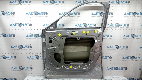 Bare front right door of a 2023 Ford Explorer, silver JS, dents, bumps, scratches