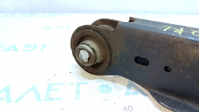 The lower control arm under the rear left spring of a Toyota Prius 50 Prime 16-22 is rusty, the silent block needs replacing