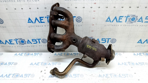 The exhaust manifold with a catalytic converter for a Toyota Prius 50 16-21 is rusty and has a broken bolt.