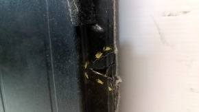 The trunk floor of a 12-17 Toyota Prius V beige, torn