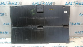 The trunk floor of a 12-17 Toyota Prius V beige, torn