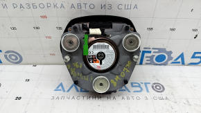 The Honda Insight 19-22 driver's steering wheel airbag is black and scratched.