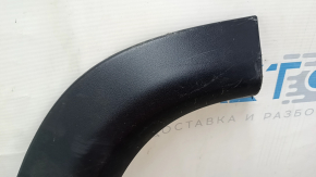 The lower rear left door trim of a Jeep Compass 17-24 is worn and scratched.