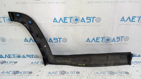 The lower rear left door trim of a Jeep Compass 17-24 is worn and scratched.