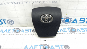 The driver's steering wheel airbag for a Toyota Prius 30 10-15 is black and scratched.