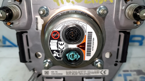 The Toyota Venza 21-24 driver's steering wheel airbag is black and scratched.