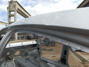 Metal roof of a Chevrolet Volt 16-on-body, dented