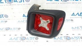 Right headlight for a 1995 Jeep Renegade (pre-restored) with graphite frame and scratches.