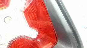 Right headlight for a 1995 Jeep Renegade (pre-restored) with graphite frame and scratches.