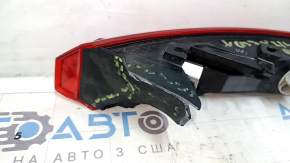 The right outer fender light of a Toyota Venza 21-24 has broken fasteners.