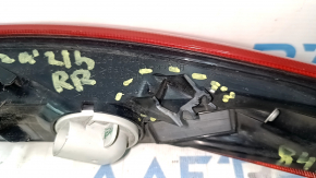 The right outer fender light of a Toyota Venza 21-24 has broken fasteners.