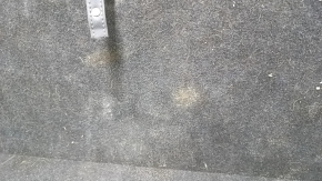 The trunk floor of a 2018 Toyota Venza, black Limited, XLE, needs dry cleaning. The handle is defective, it is worn, dented, and torn.