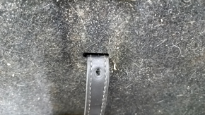 The trunk floor of a 2018 Toyota Venza, black Limited, XLE, needs dry cleaning. The handle is defective, it is worn, dented, and torn.