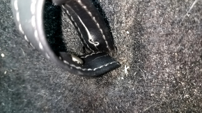 The trunk floor of a 2018 Toyota Venza, black Limited, XLE, needs dry cleaning. The handle is defective, it is worn, dented, and torn.