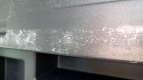 The trunk tray of a Toyota Venza 21-24 is black, scratched, dented, and the plastic has turned white.