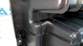 The trunk tray of a Toyota Venza 21-24 is black, scratched, dented, and the plastic has turned white.