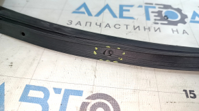 The rear right door seal of a Toyota Venza 21-24 has torn fasteners.