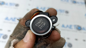 The Alfa Romeo Stelvio 18-25 start/stop button is black and the coating is peeling off.