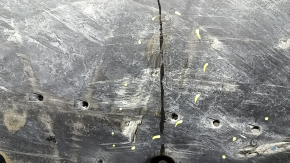 The front left underbody protection of Toyota Venza 21-24 is broken, scuffed, and dented.