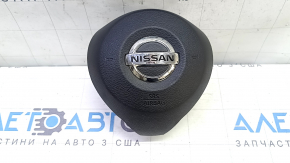 The driver's side airbag in the steering wheel of a Nissan Rogue Sport 20-22 is black and scratched.