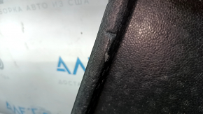 The right trunk tray of the Ford Bronco Sport 21-25 is dented and has tears.