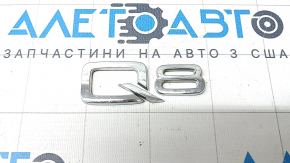 The Q8 emblem on the tailgate of the Audi Q8 19-25 is chrome.