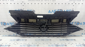 The grille assembly with the Nissan Quest 12-14 badge, camera, and molding is broken, worn, missing a fragment, broken fasteners, and peeling chrome.