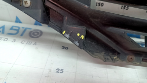 The grille assembly with the Nissan Quest 12-14 badge, camera, and molding is broken, worn, missing a fragment, broken fasteners, and peeling chrome.