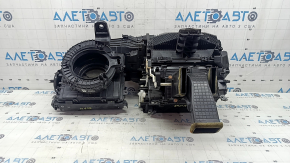 The bare heater housing of a 2015 Ford Bronco Sport, assembled in 3 parts, is broken.