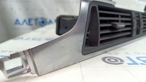 The central air vent for the front panel of the Audi A6 C7 16-18 is black, with a chrome trim, bumps on the chrome, scratches