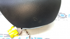 Black, worn steering wheel airbag for the driver's side of a VW Jetta 19-24.