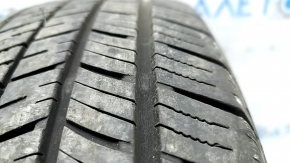 The 2020 Yokohama Avid Ascend GT 5mm R15 195/65 all-season tire is cracked and cut.