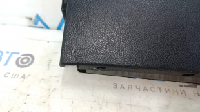 The Audi A6 C7 12-18 black under-seat storage compartment has scratches and cracks in the mounting points.