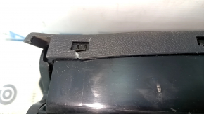 The Audi A6 C7 12-18 black under-seat storage compartment has scratches and cracks in the mounting points.