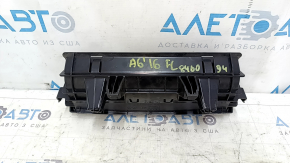 The Audi A6 C7 12-18 black under-seat storage compartment has scratches and cracks in the mounting points.