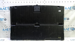 The trunk floor of a 15-17 Toyota Prius V is black, with scratches on the handle.