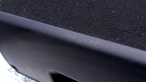 The battery cover of a 15-17 Toyota Prius V is black and scratched.