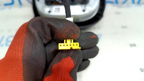 The driver's side airbag in the Jeep Compass 22-25 is black and has a rusty squib.