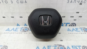 The Honda CRV 23-25 driver's steering wheel airbag is black and has a rusty squib.