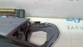 The outer front left door handle of a Volkswagen ID.4 21-22 keyless entry system is cracked and missing a component. The latch is broken.
