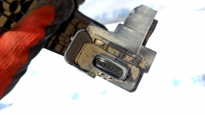 The gas pedal on a 1920 Kia Optima is missing a plug.