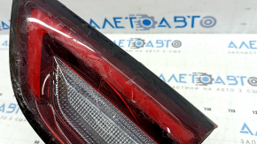The right inner taillight of the Ford Escape MK4 2023-2024 has cracks, glue, and scratches.