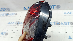 The right inner taillight of the Ford Escape MK4 2023-2024 has cracks, glue, and scratches.